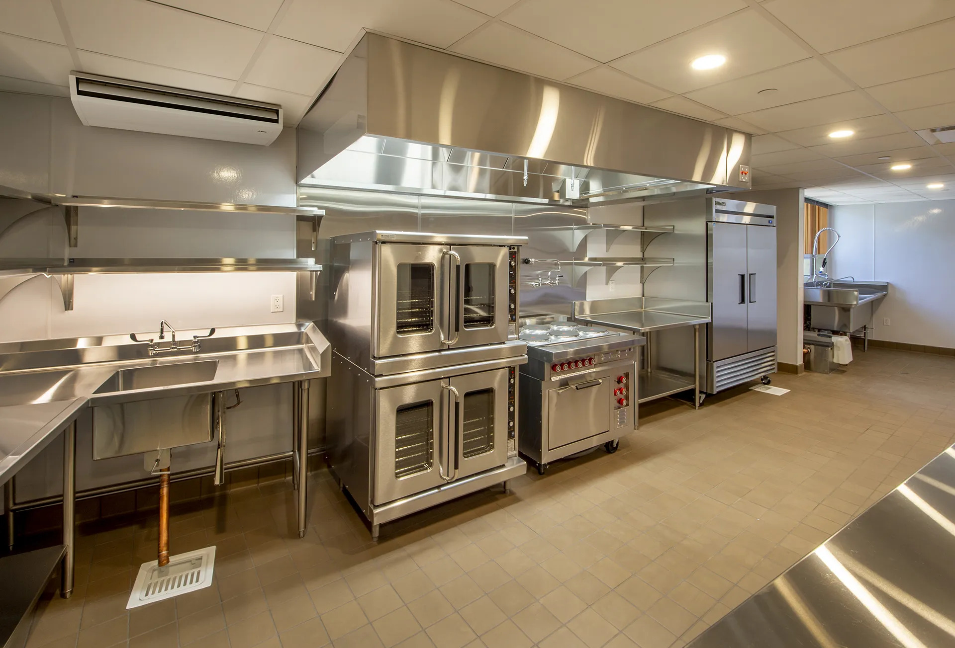 https://tudorhvac.com/wp-content/uploads/2026/07/ME_PCFY_Trane_Mech_Industrial_kitchen_1575c49116-mitsubishi-commericla-ceiling-suspnded.jpg